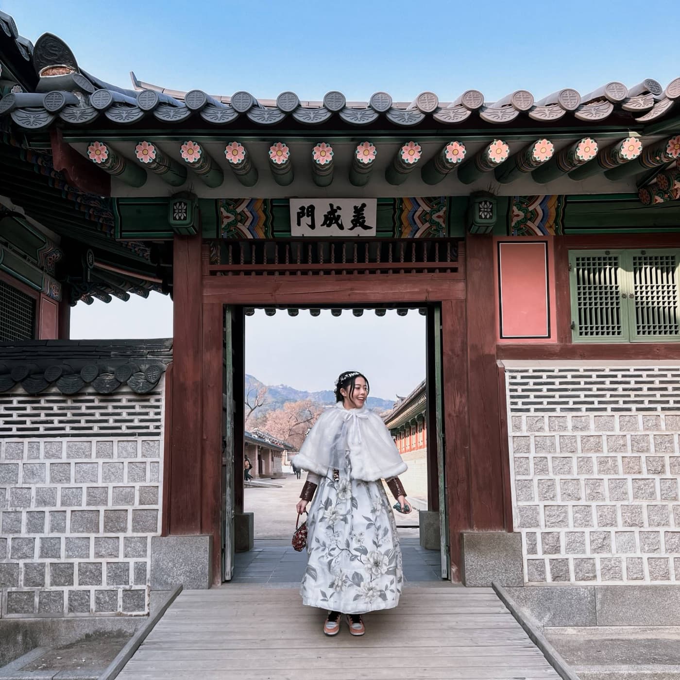Janice Low smiling in a hanbok at Gyeongbokgung Palace, Seoul